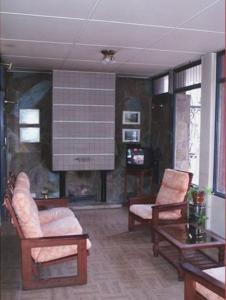 a living room with two chairs and a fireplace at Hotel Dali in San Rafael