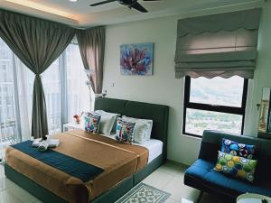a bedroom with a bed and a couch and a window at D'Gunduls Homestay STUDIO by DGH I-CITY in Shah Alam