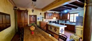 a kitchen with wooden cabinets and a wooden table at Hotel Casa Real Antigua in Antigua Guatemala
