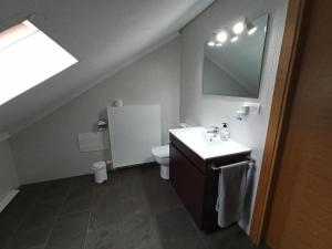 a bathroom with a sink and a toilet at A casa da Balbina in Betanzos +23 photos