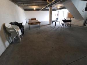 an empty room with chairs and tables in a building at A casa da Balbina in Betanzos