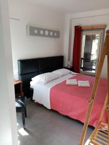 a bedroom with a large bed with a red blanket at Le Relais de Monti in Menton