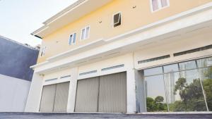 a house with two garage doors at City Residence Kutai 32 in Surabaya