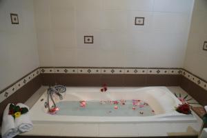 a bath tub with flowers in the middle of it at Oceanic Villa in Grand-Baie