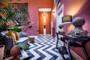 a living room with a couch and some plants at Hotel Ungherese Small Luxury Hotel in Florence