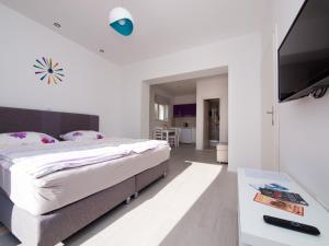 a bedroom with a bed and a flat screen tv at Apartments F & P in Dubrovnik