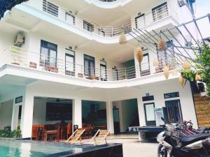 a building with a pool in front of it at Tam Coc Victoria Hotel in Ninh Binh