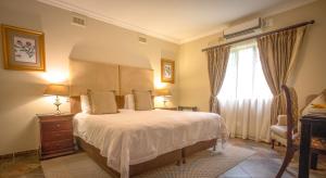 a bedroom with a large bed and a window at At Heritage House in St Lucia +63 photos