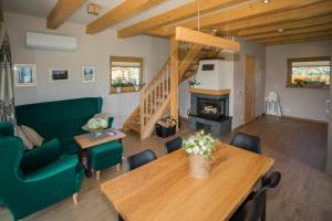 a living room with a table and a fireplace at Apartamenty Zielone Skałki in Kluszkowce