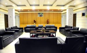 a waiting room with black leather chairs and a table at Sreemangal Inn Hotel & Restaurant in Sreemangal