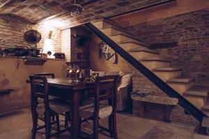 a dining room with a table and some stairs at La Dimora del Pataca in Rimini