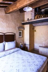 A bed or beds in a room at La Dimora del Pataca