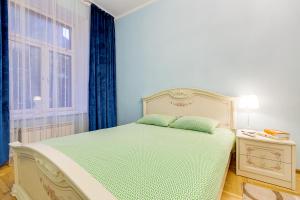 a bedroom with a bed and a window at Apartment Marata 10 in Saint Petersburg