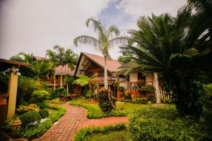 een huis met een gruwelijke tuin en een pad bij Hortz Hotels And Resorts in Tagaytay