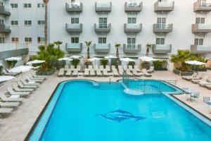 a swimming pool in front of a hotel at Bora Bora Ibiza Malta Resort - Music Hotel - Adults Only 18 plus in St Paul's Bay