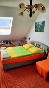 a bedroom with a large bed and a ceiling at Penzion na Figleně in Slatinice