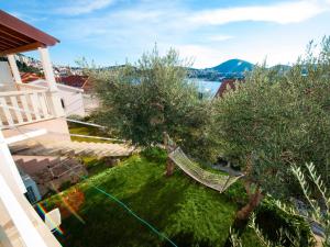 a hammock in the yard of a house with trees at Apartments F & P in Dubrovnik