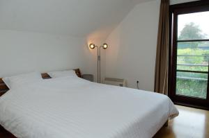 Säng eller sängar i ett rum på Vakantiehuis - Rue du Château Deux