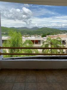 a balcony with a view of a city at Casa en Oasis en Xochitepec in Chiconcuac