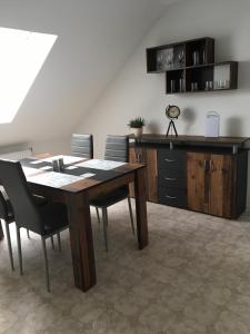 a dining room with a wooden table and chairs at Schmidtapartment in Weimar