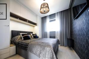 Posteľ alebo postele v izbe v ubytovaní Luksusowy apartament z tarasem
