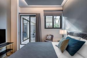 מיטה או מיטות בחדר ב-Muse Urban Suites