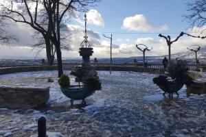 a park covered in snow with a fountain and trees at Casa Mercedes. Laguardia (Alava) in Laguardia