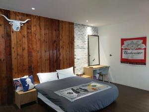 a bedroom with a bed with a cow head on the wall at Original Bnb in Tainan