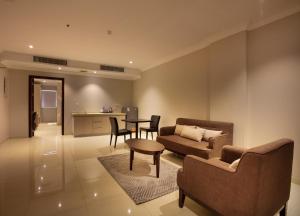 a living room with a couch and a table at SOMEDAYS Serviced Apartments - Standard in Al Hofuf