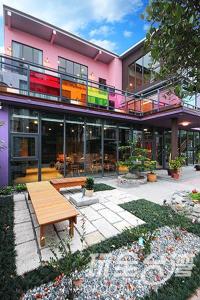 a pink building with a bench in front of it at Yes Villa in Luodong