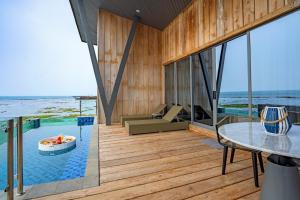 a house on the beach with a view of the ocean at ASTON Anyer Beach Hotel in Anyer