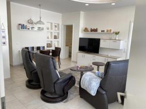 a living room with black chairs and a table at Norderneytraum Kampstr. Whg. 3 in Norderney