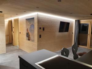 a kitchen with a sink and a tv on the wall at Chaletwohnung Dorfbrunnen in Oy-Mittelberg