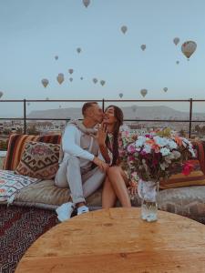 a man and a woman kissing on a couch at Wonder of cappadocia in Goreme