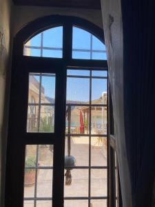 an open door with a view of a playground outside at Kasr-ı Canan in Halfeti