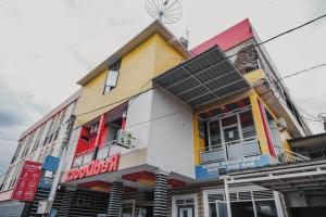 a building with a windmill on top of it at RedDoorz @ Jalan STM Medan in Medan