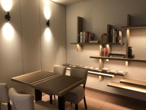 a dining room with a table and chairs and shelves at Hotel Duivels Paterke Harelbeeksestraat 29, 8500 Kortrijk in Kortrijk