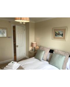 a bedroom with a bed with two pillows at 31 Queens Road in Winchester