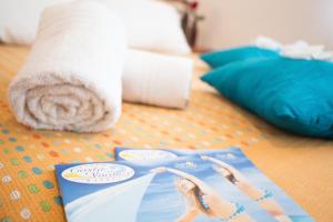 a magazine sitting on a floor with a towel at Gallia Club Hotel in Cesenatico