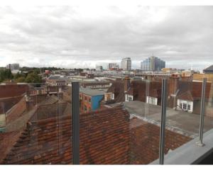 a view of a city with buildings and roofs at Penthouse apartment in Basingstoke in Basingstoke