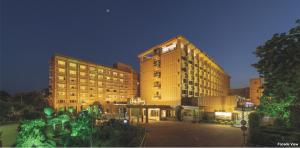 a large hotel building at night with its lights on at Hotel Clarks Shiraz in Agra