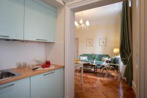 a kitchen with a table, chairs and a refrigerator at Serristori Palace Residence in Florence
