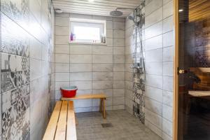 a small bathroom with a bench and a window at Cosy Family Guesthouse with Sauna and Garden in Kuressaare