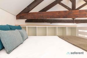 a bedroom with a white bed with blue pillows at Flores - Delight Loft Porto - Next to Ribeira in Porto
