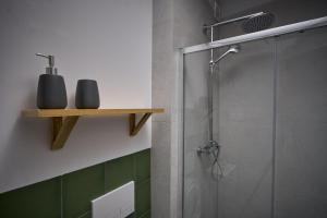 a bathroom with a shower with a glass door at Apartamenty Ponidzie in Busko-Zdrój +28 photos