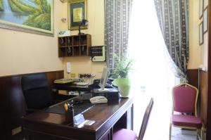 an office with a desk with a computer on it at Hotel Farini in Rome