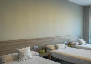 Posteľ alebo postele v izbe v ubytovaní Apartamentos Santa Clara