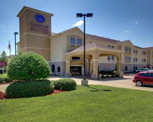a building with a car parked in front of it at Comfort Suites Tyler South in Tyler