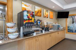 a restaurant kitchen with a counter with aperature at Comfort Suites Salem in Salem