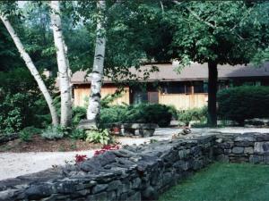 a stone wall in front of a house at The Cottage in Stockbridge